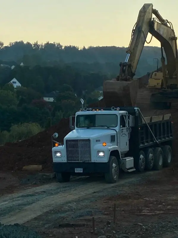 Brooks Hauling dump truck loaded by excavator