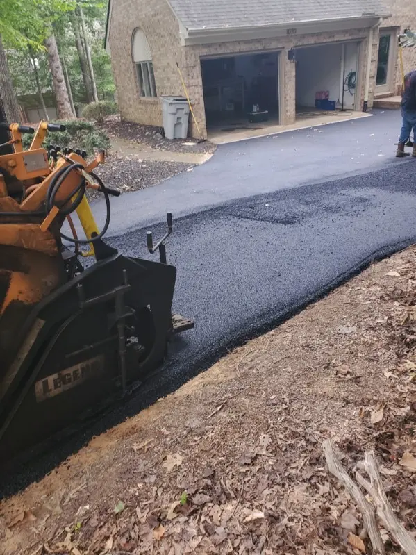 Asphalt paver laying a residential driveway